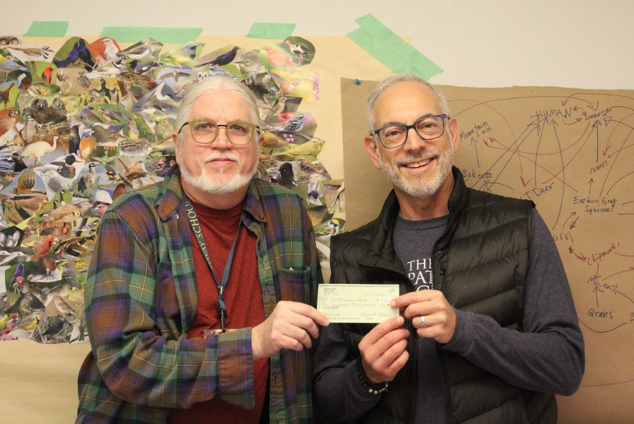Wayne Stratz presents check on behalf of Nutmeg Designs to Jory Barrad for The Pathway School.